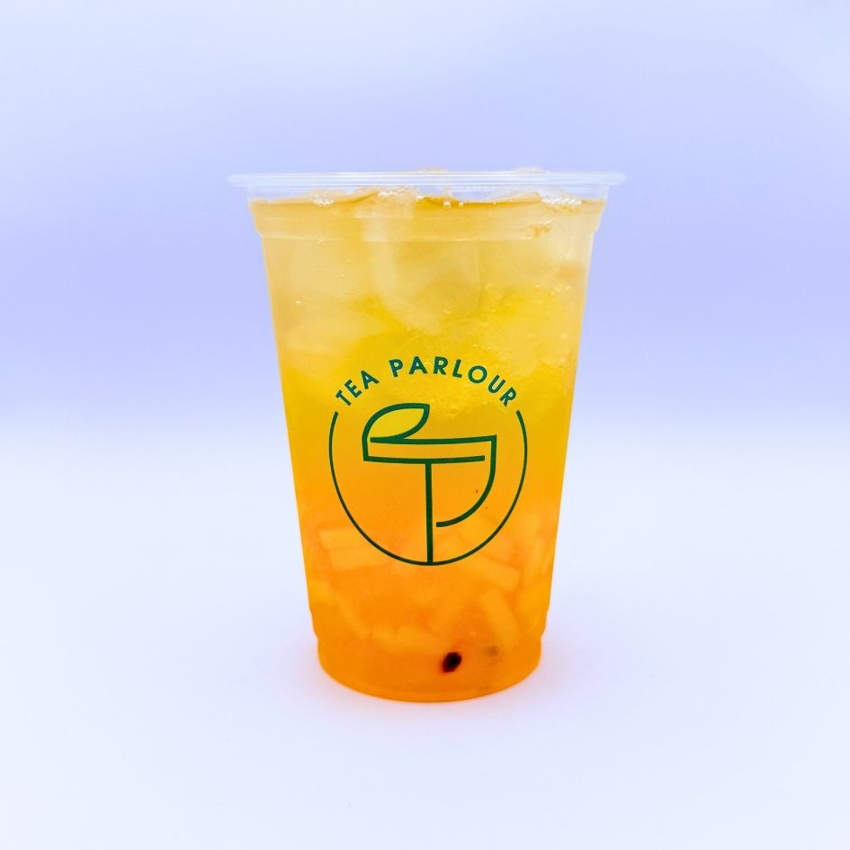 fruit tea with served in a clear Tea Parlour cup on a soft pastel background.