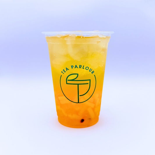 fruit tea with served in a clear Tea Parlour cup on a soft pastel background.