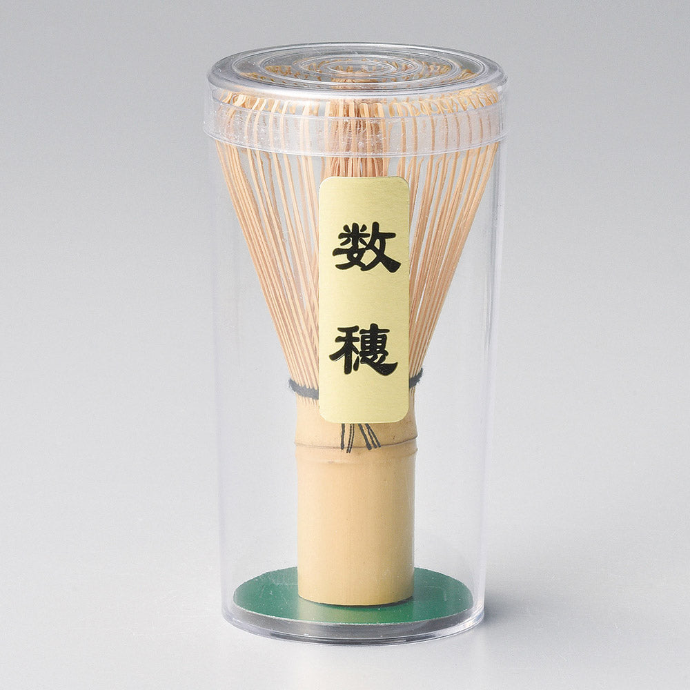 Bamboo whisk in a clear cylindrical container